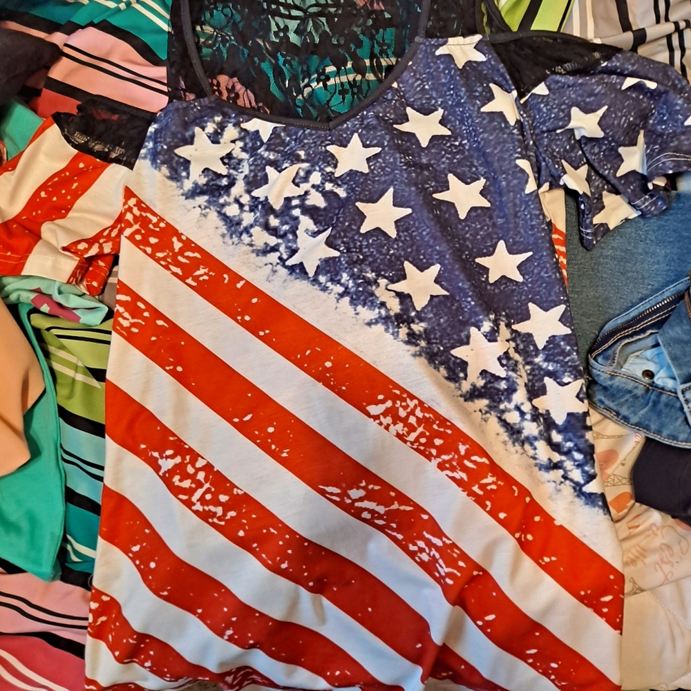 Red, white and blue top that has the sleeves off the shoulder.